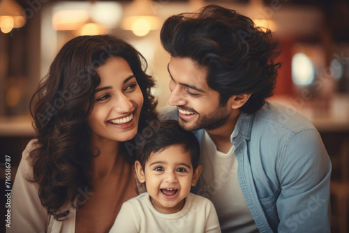 Young Indian ethnic parents and their child having fun time in a restaurant 