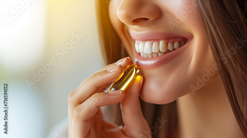 healthy eating concept, woman taking fish oil hand holding capsule vitamin photo
