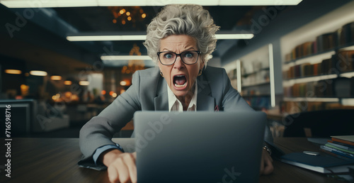 Frustrated woman using computer and screaming