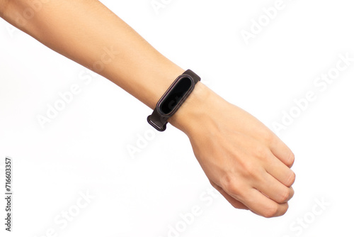 Cropped shot of a woman's hand holding a smart watch with a black display isolated on a white background. Fitness bracelet with copy space close-up. Concept of time, health care, modern digital gadget