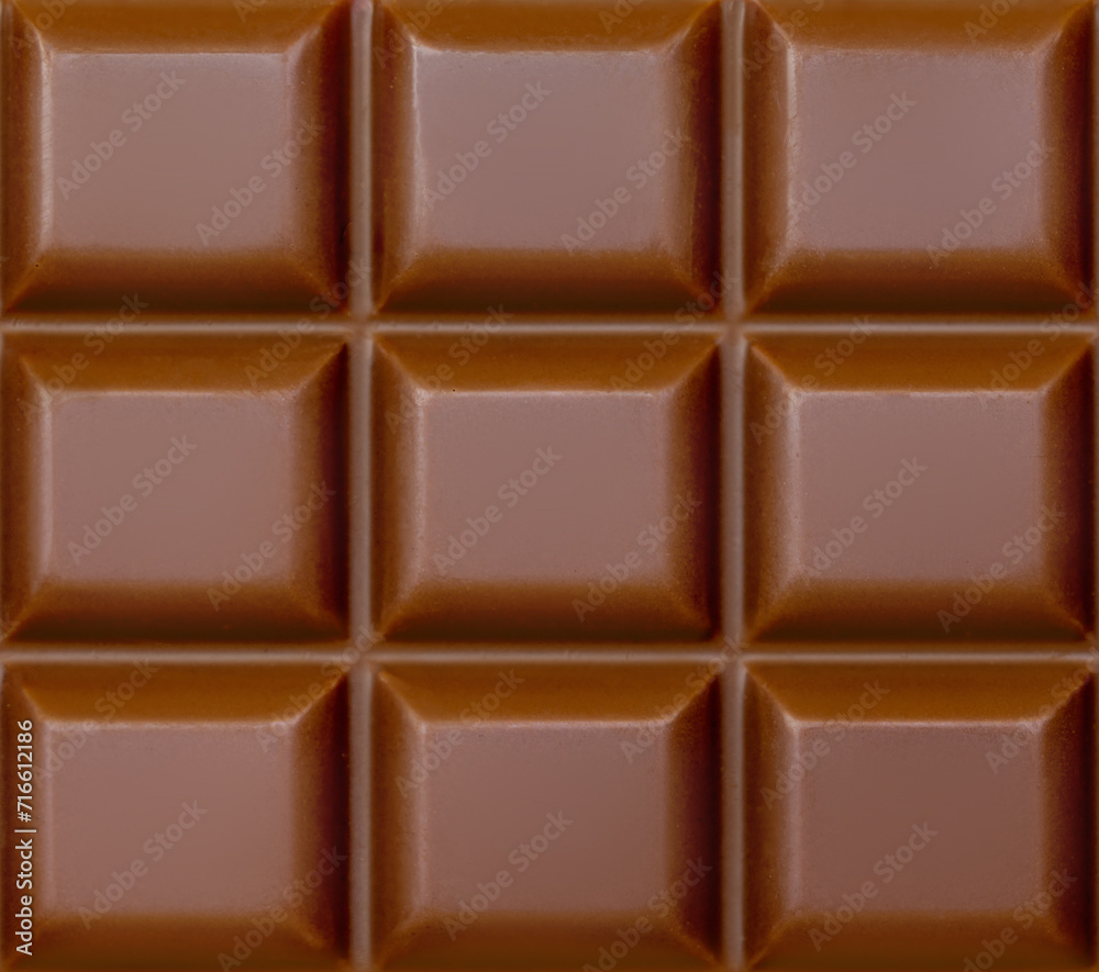 Milk chocolate bar textured background. Chocolate Pattern. High resolution image close up
Milk chocolate bar textured background. Chocolate Pattern. High resolution image close up