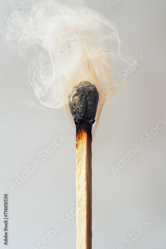 Smoking blown out match on a beige grey background - Generative AI