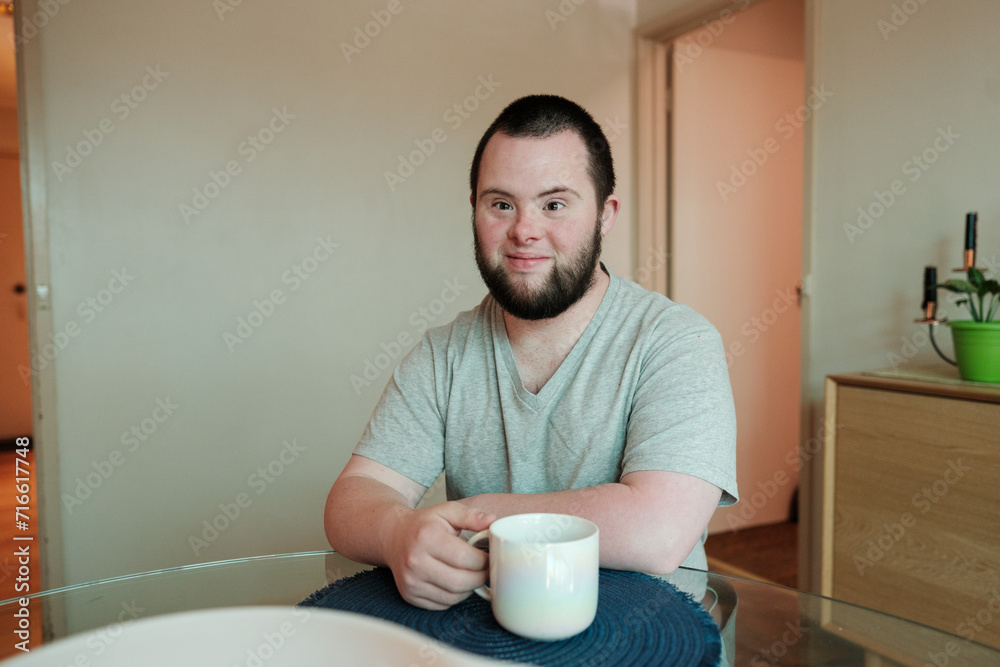 Young Man with Down Syndrome Having a Cuppa Young Man with Down Syndrome Having a Cuppa
