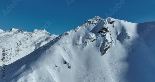 Winter drone shot of ski pistes and slopes covered with fresh powder snow in Tignes in Valdisere France photo