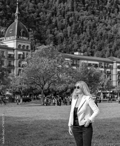 Vacation in Switzerland - Interlaken. Concept of tourism and holidays. Woman in city streets, urban scene