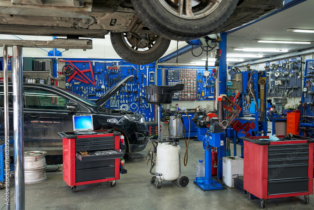 Inside the confines of a compact, modern mechanic workshop – a snapshot of efficiency, technology, and automotive expertise. Inside the confines of a compact, modern mechanic workshop – a snapshot of efficiency, technology, and automotive expertise.