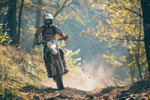 Motocross rider on the race track in the autumn forest. Motocross. Enduro. Extreme sport concept.