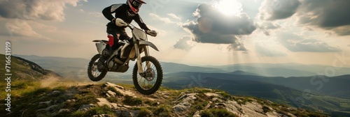 Motocross rider on the high mountain. Extreme sport concept. Motocross. Enduro. Extreme sport concept. © John Martin