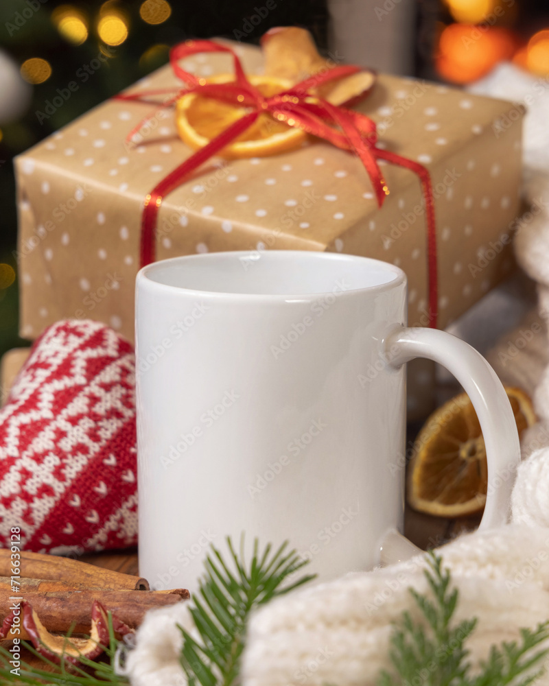 White coffee mug near Christmas present, cosy heart and sweater, winter mockup
