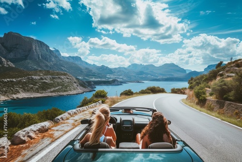 friends in convertible on a road trip in mountains and sea view on the sunset © Наталья Добровольска