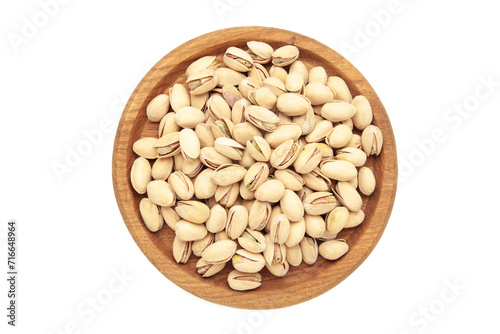 Salted pistachios for beer isolated on white background. Healthy delicious pistachios in wooden plate.
