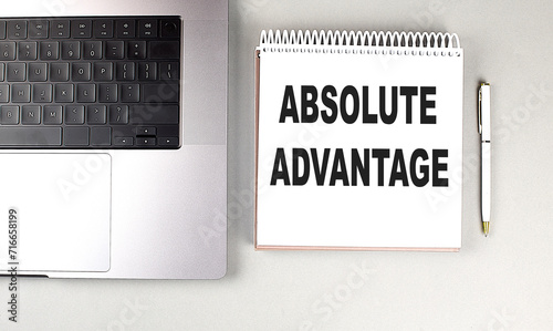 ABSOLUTE ADVANTAGE text on notebook with laptop and pen