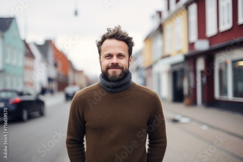 Portrait of a satisfied man in his 30s wearing a classic turtleneck sweater against a charming small town main street. AI Generation © CogniLens