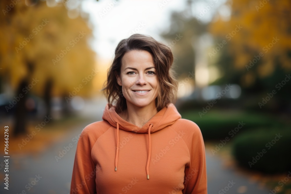 Portrait of a content woman in her 40s dressed in a comfy fleece pullover against a vibrant city park. AI Generation Portrait of a content woman in her 40s dressed in a comfy fleece pullover against a vibrant city park. AI Generation
