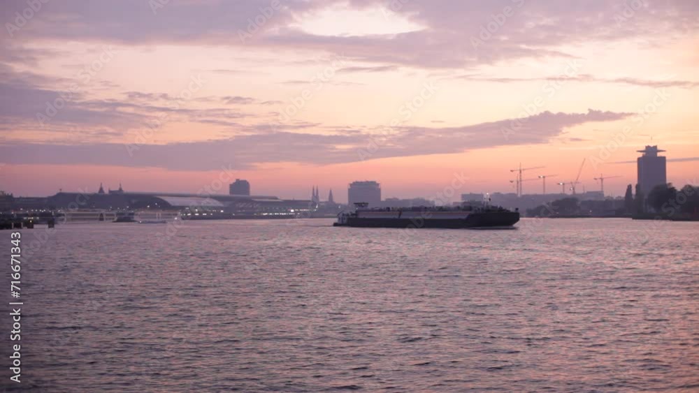 Cityscape and IJ River at sunset, Amsterdam, The Netherlands Cityscape and IJ River at sunset, Amsterdam, The Netherlands