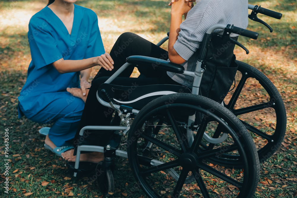 young asian physical therapist working with senior woman on walking with a walker