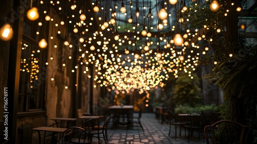 a patio with a lot of lights hanging from it's ceiling and a table with chairs in the background