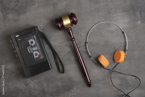 Music piracy and copyright protection law concept, gavel, tape recorder and headphones on table photo