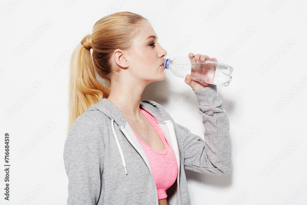 Woman, drinking water and workout in studio profile, thinking and vision for fitness by white background. Girl, model and person with bottle, liquid and hydration for detox, wellness and nutrition Woman, drinking water and workout in studio profile, thinking and vision for fitness by white background. Girl, model and person with bottle, liquid and hydration for detox, wellness and nutrition