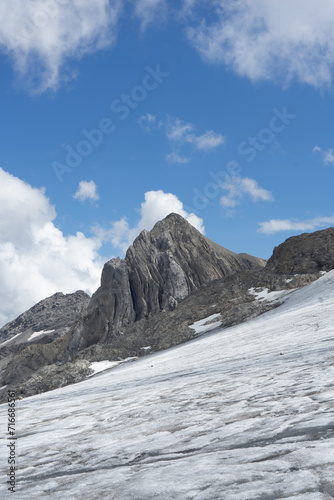 Majestic mountain peak towering over a snowy landscape under a clear blue sky