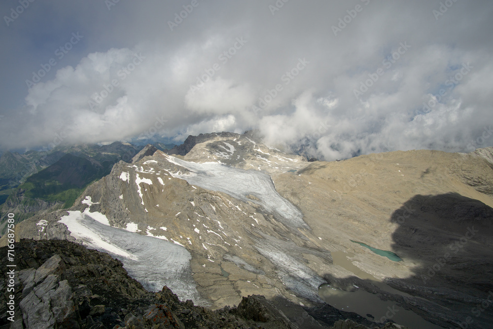 A scenic view of an expansive mountain range under a cloudy sky