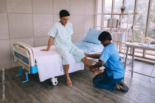Female doctor examining patient's leg during injury check in hospital