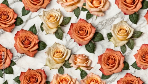  a close up of a bunch of roses on a marble surface with leaves and flowers in the middle of the image on a white marble surface with a marble background.
