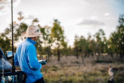 Man with remote control looking into distance photo
