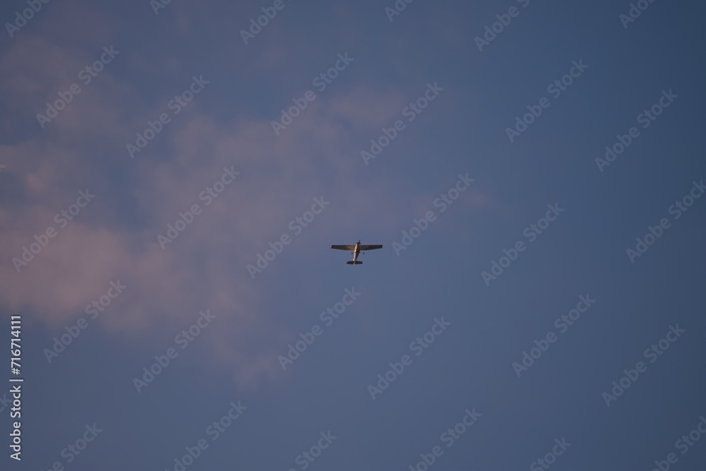 Small plane flying in the blue sky. Single engine Cessna aircraft model Small plane flying in the blue sky. Single engine Cessna aircraft model