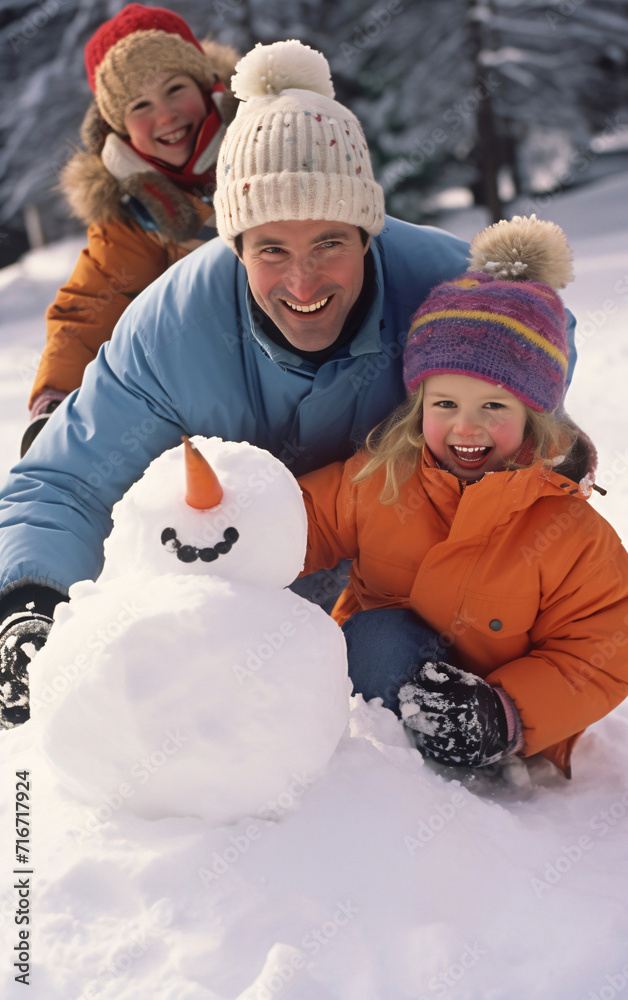 Happy family father and daughters made a snowman, winter wellness and activity