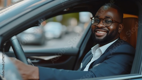 Portrait of a happy black businessman driving a luxury car, generative AI © Hifzhan Graphics
