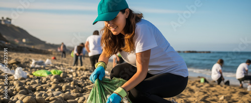 Volunteer woman cleaning beach to protect the environment photo