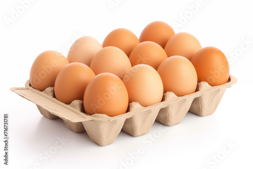 Raw chicken eggs in egg box on a white background