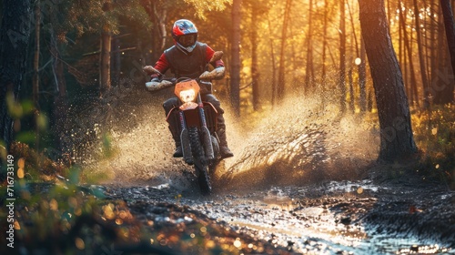 Motocross rider on a motorcycle in the forest at sunset. Motocross. Enduro. Extreme sport concept. © John Martin