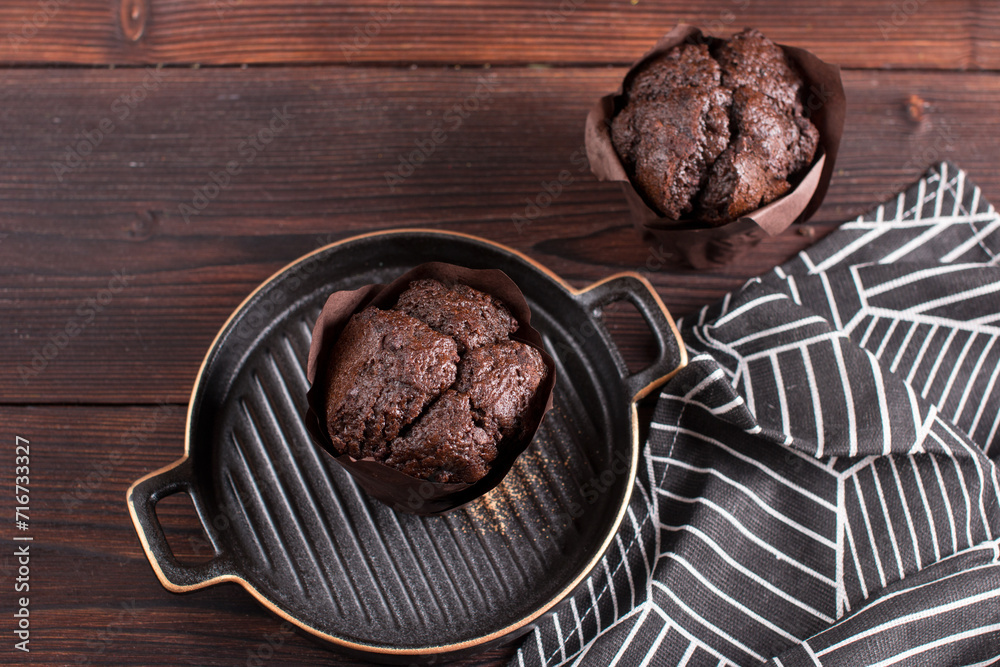 Fototapeta premium Making muffin cupcake in the kitchen. Chocolate pastries on a plate