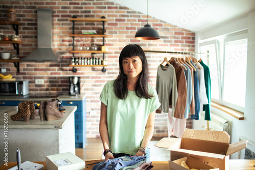 Portrait of a entrepreneur woman with clothing business from home photo