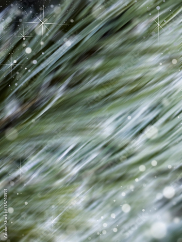 Winter background with snowflakes and grass. Blurred image.