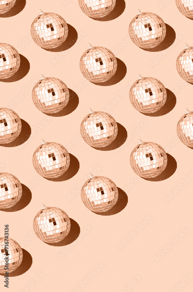 Color of the year 2024 peach fuzz..Shiny disco balls. Creative Christmas pattern. 90s retro party time concept. Xmas holiday background. Top view. Flat lay Color of the year 2024 peach fuzz..Shiny disco balls. Creative Christmas pattern. 90s retro party time concept. Xmas holiday background. Top view. Flat lay