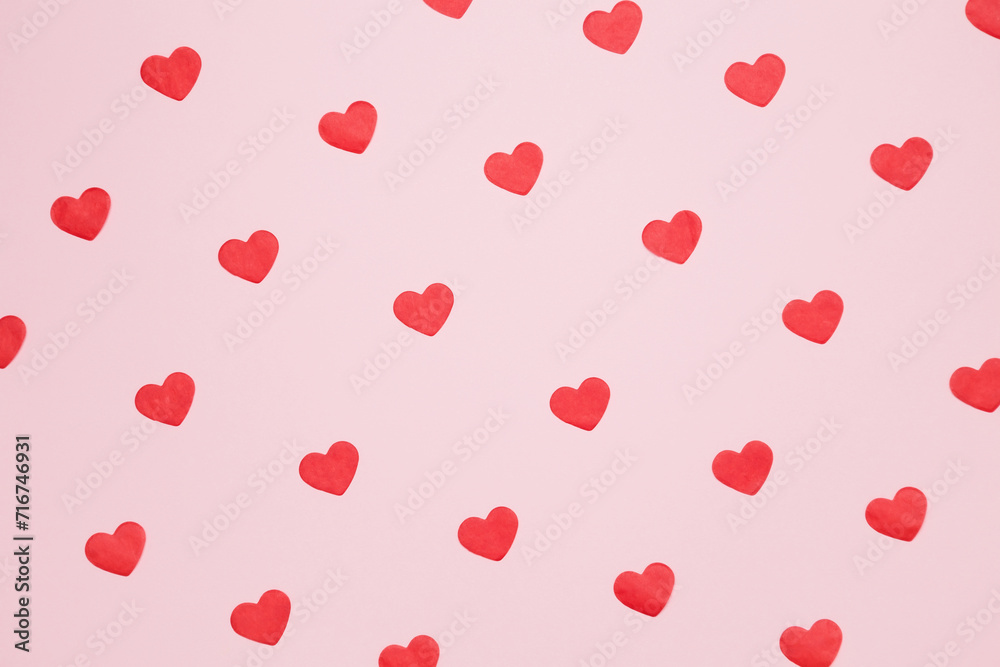Paper hearts on a pink background for Valentine's Day, happy anniversary. Top view