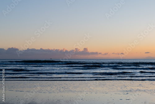 ocean sea with pastel vibrant colors, tranquil waves, and coastal beauty, ideal for relaxation, travel, pink skies and clouds
