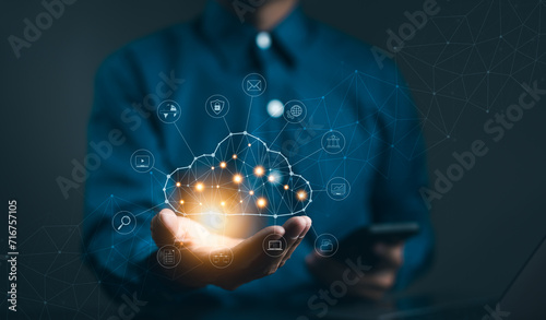Cloud computing technology concept. Businessman hand holding cloud computing icon network. download and information upload on application system. data transfer loading solution, Secure online storage, photo