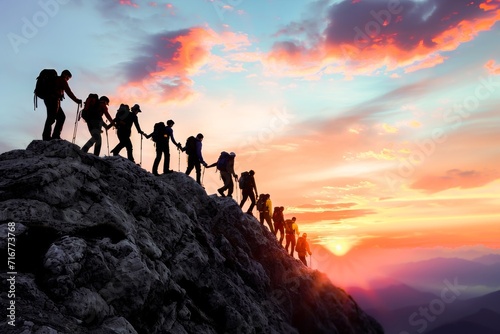 A group of hikers reaching the summit of a mountain against a vibrant sunset sky  symbolizing adventure and accomplishment.