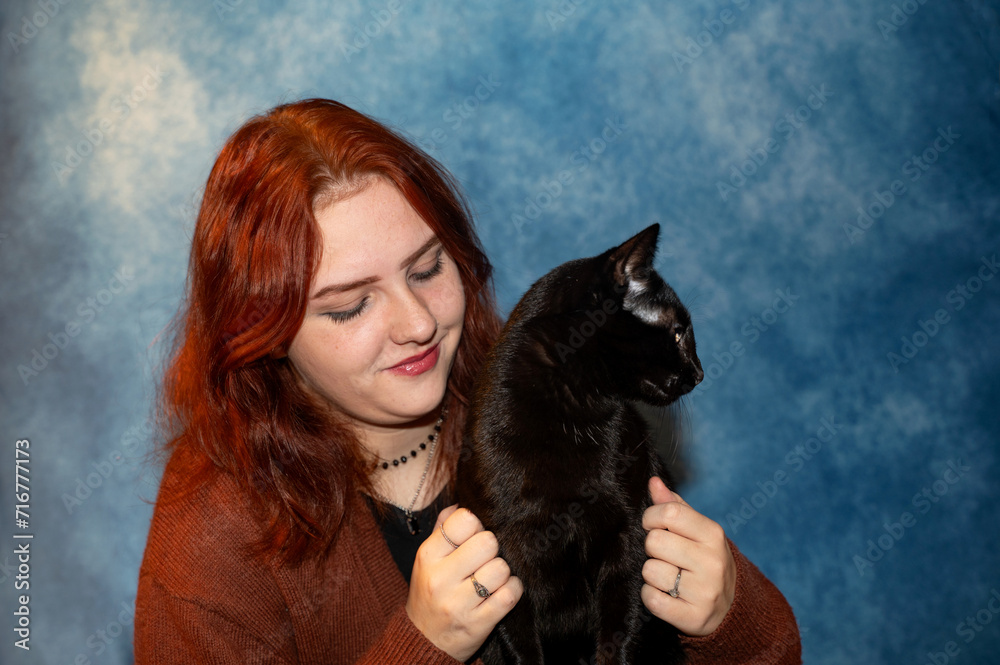 Young woman with her black cat Young woman with her black cat