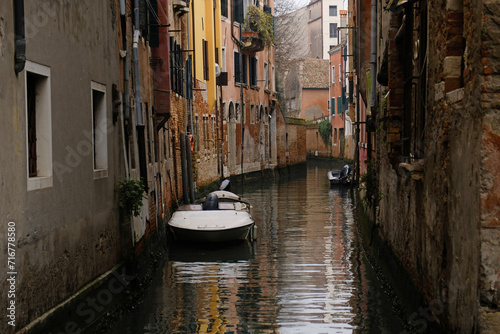 Fototapeta Naklejka Na Ścianę i Meble -  Typical narrow streets and canals between сolorful and shabby houses in Venice, Italy. 