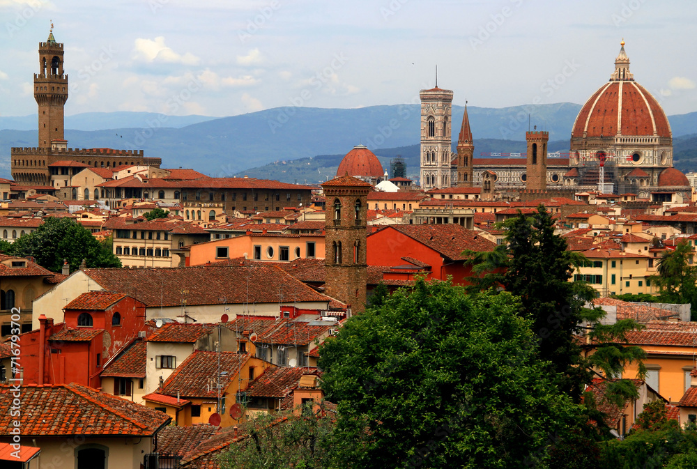 Panoramic view of the historic part of Florence with the Cathedral Cattedrale di Santa Maria del Fiore and Palazzo Vecchio building against a background of the mountains in the Tuscany region of Italy