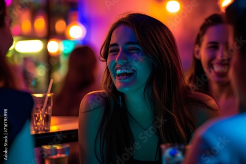 A vibrant woman radiates joy as she shares a lighthearted moment with friends at a bustling nightclub, her beaming smile and stylish clothing adding to the lively atmosphere