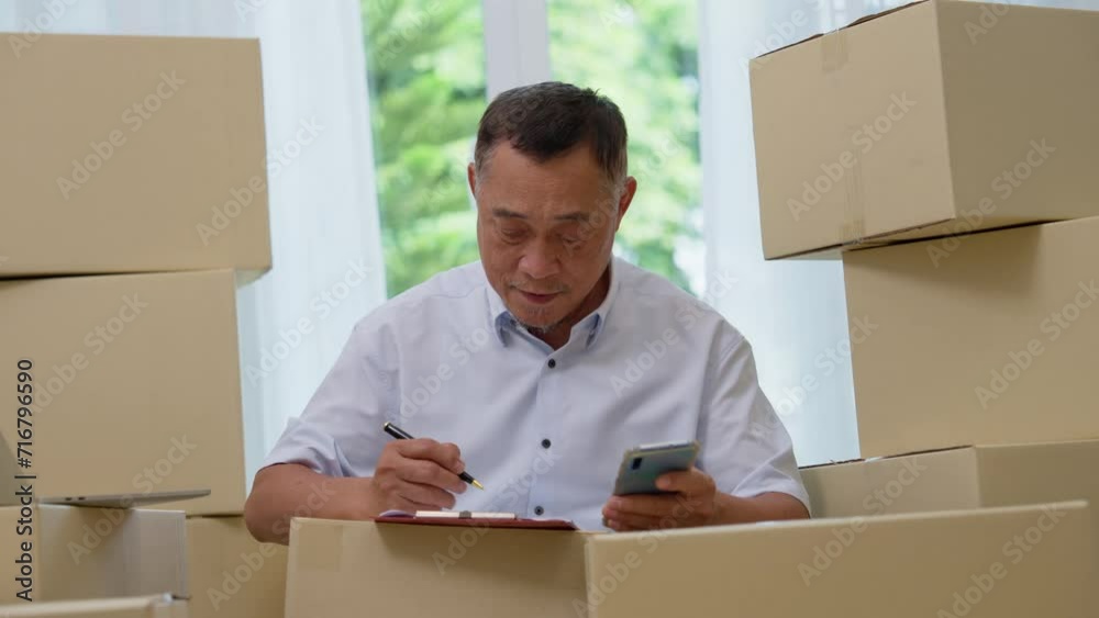 Asian elderly older using laptop and smartphone for checking email order at home office SMEs , Startup small business entrepreneur working online marketing after retirement, merchant seller concept Asian elderly older using laptop and smartphone for checking email order at home office SMEs , Startup small business entrepreneur working online marketing after retirement, merchant seller concept