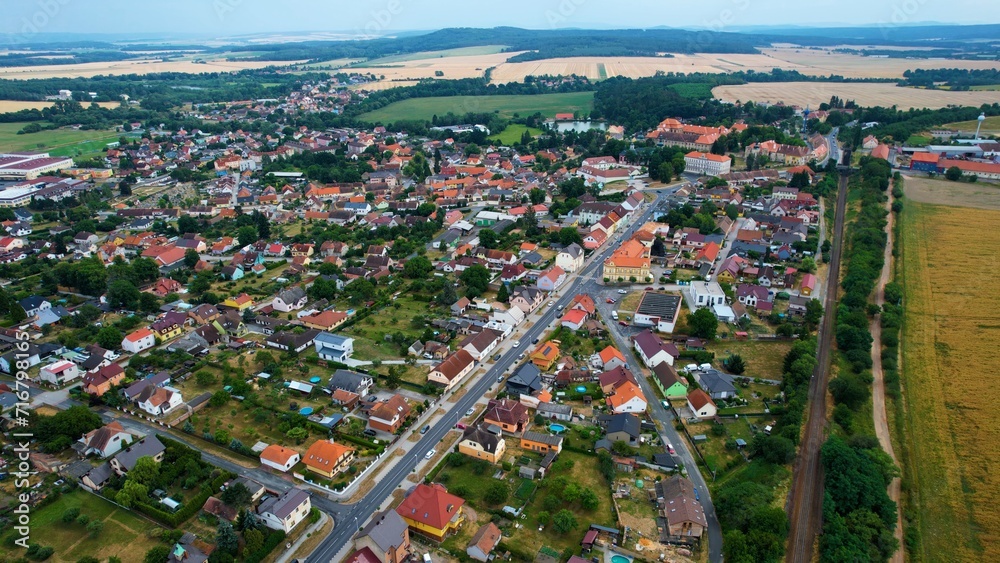 Aerial around the old town and monastery Chotesov  in the Czechia on a cloudy day in summer