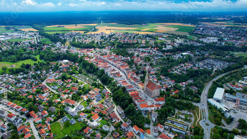 Aerial around the old town of the city Neuoetting in Bavaria on a cloudy day in summer