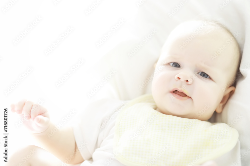 Maternity concept. A young mother feeds her little baby. First lure and breastfeeding. Family in white clothes. Maternity concept. A young mother feeds her little baby. First lure and breastfeeding. Family in white clothes.